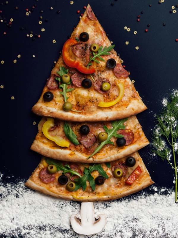 Pizza slices placed to make a Christmas tree shape