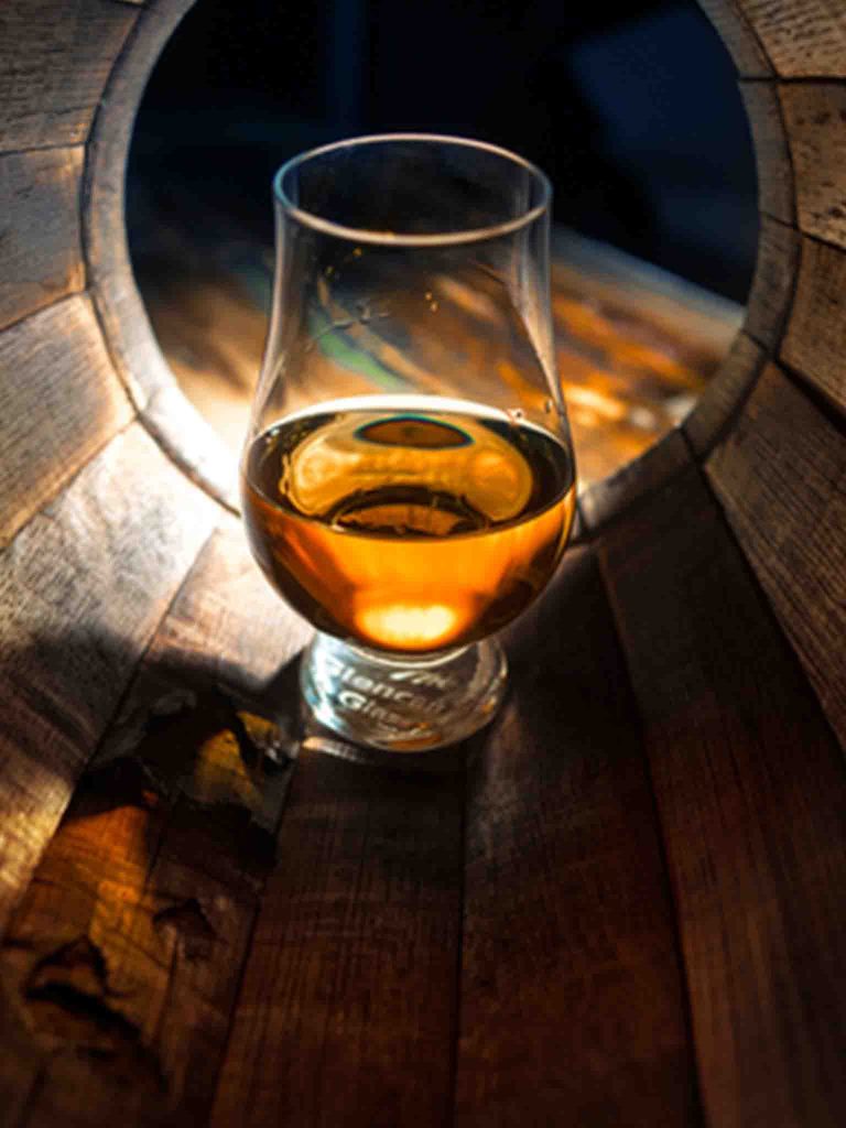 A dram of whisky in a whisky barrel