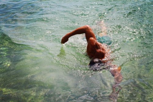 A man doing front crawl in the sea