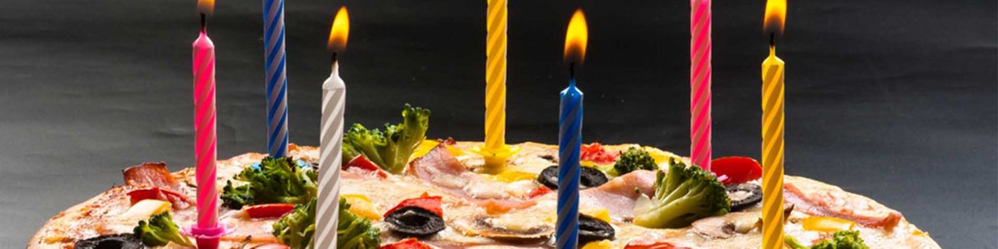 A birthday pizza with candles on it