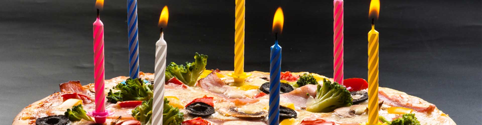 A birthday pizza with candles on it