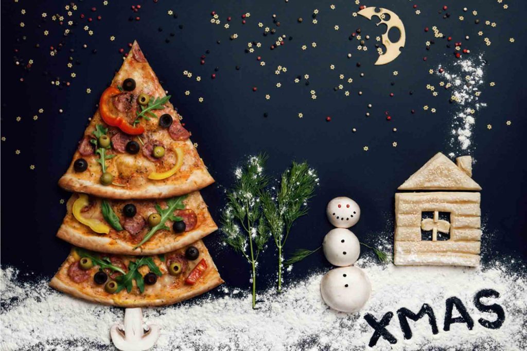 A Christmas scene made with pizza and pizza ingredients