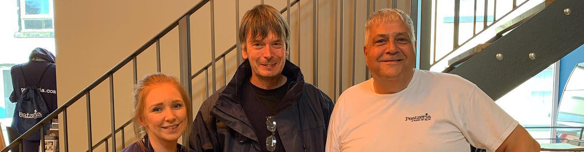 Scottish writer Ian Rankin with staff members of Peatzeria Restaurant