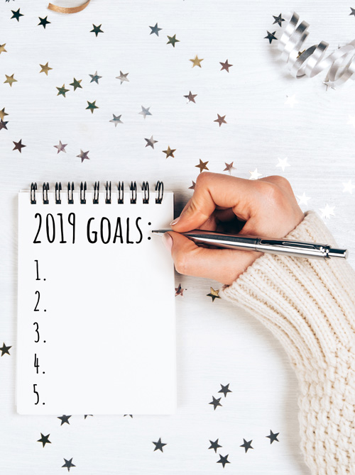 Writing 2019 goals on a notepad