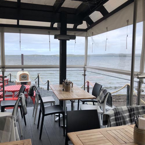 Pizza restaurant with large windows and sea view