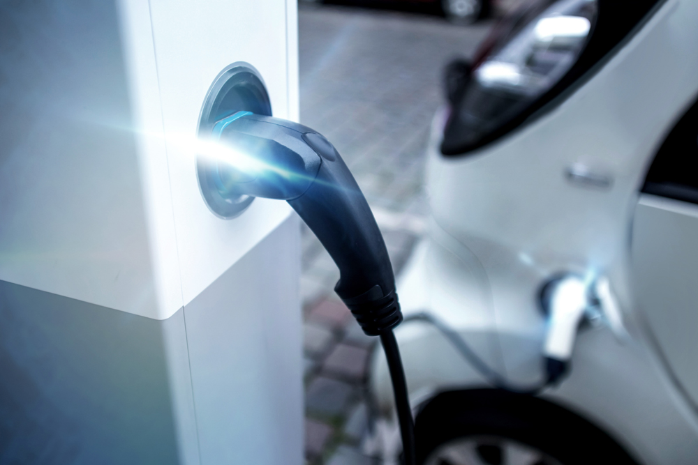 An electric car charging at a charge point