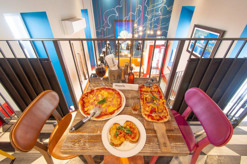 Selection of pizzas on a table at Peatzeria restaurant