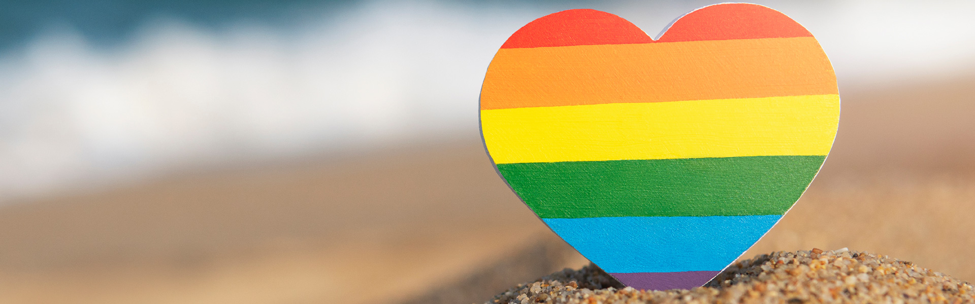 Rainbow heart representing LGBT movement, on the beach