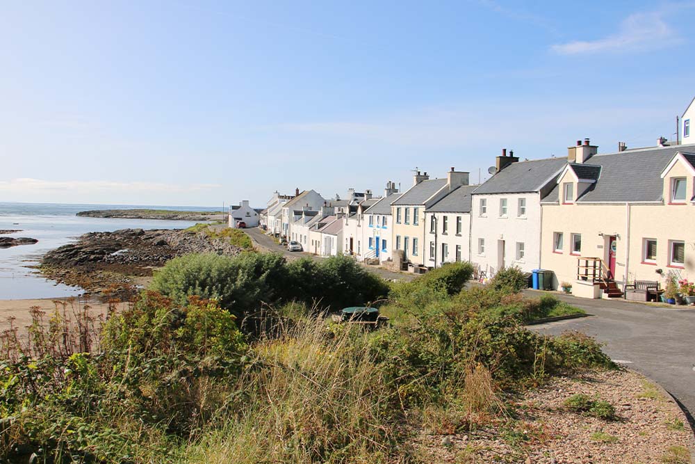 A line of white Islay homes along the coastline