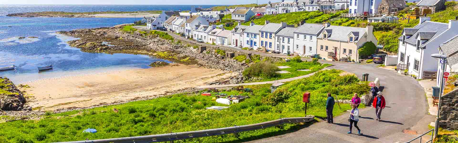 A group of visitors walking up the road on Islay