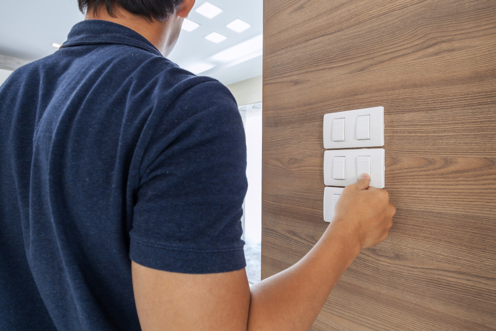 Man switching off lights in hotel room