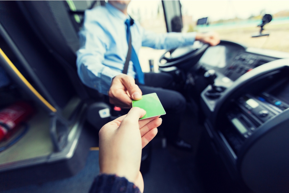 A person handing over a pass on local transport