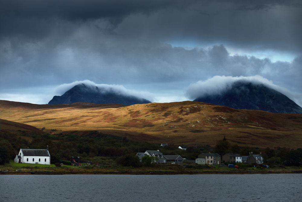 Panoramic view of the valley near the Paps of Jura under the colorful stormy sunset sky.
