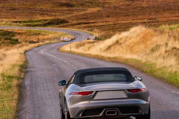 A car on a highland road in Scotland.