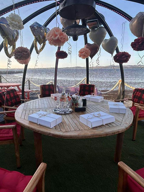 Outdoor seating at Peatzeria with views.